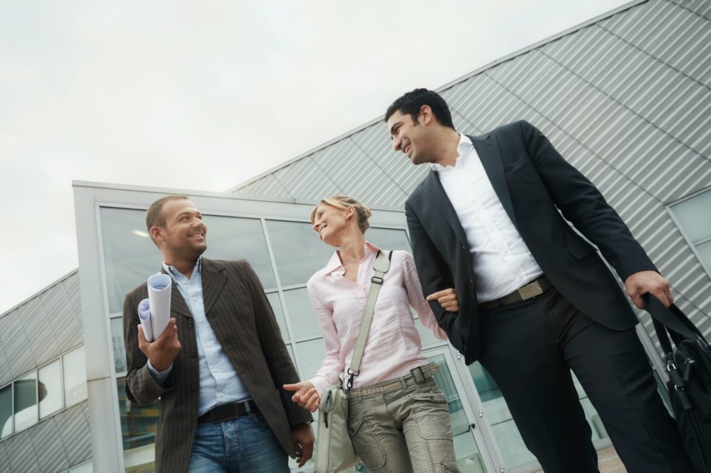 Team Of Architects Walking Outside Office